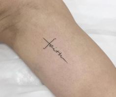 a person's arm with the word faith written in cursive writing on it