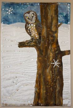 an owl sitting on top of a tree branch with snowflakes in the background