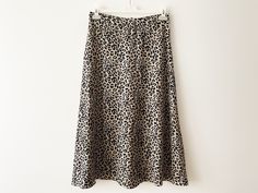 "Vintage Animal print midi skirt, a-line women's skirt, lightweight leopard print skirt, beige black cheetah print women skirt, gift idea for her Measurements: Waist: 29.5\" Hips: 41\" Length: 33\" Please check measurements to insure a proper fit. Remember to allow yourself some extra room for movement. You can compare these with something from your closet that fits you well. Condition: Good vintage condition SHIPPING * I ship worldwide via Priority mail (Latvijas Pasts) from Latvia (EU). * I ship from Europe, so please allow 2 to 4 weeks for the package to arrive if you live overseas. * Europe 5 - 10 business days. Go back to my shop: YourEclecticStreet.etsy.com P.S. why buy Vintage? - Vintage is Unique! - Vintage is Eco Friendly! - Vintage is Inspirational! - Vintage is History! - Vintag Chic Flowy Leopard Print Skirt, Chic Lined Leopard Print Skirt, Chic Leopard Print Lined Skirt, Chic Leopard Print Skirt, Leopard Print Relaxed Midi Skirt, Leopard Print Relaxed Fit Midi Skirt, Summer Leopard Print Mini Skirt, Chic Leopard Print Skirt For Spring, Leopard Print Mini Skirt For Summer