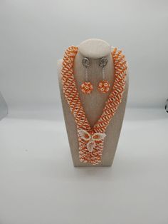 INCLUDES 1 necklace,1 bracelet and 2 earrings. COMPATIBLE fit with  African Weddings, Parties, Traditional festivals, Statement Occasions EARRINGS are pierced. Ear clips are also available. Elegant Orange Polished Beads Jewelry, Elegant Orange Jewelry With Polished Beads, Elegant White Dangling Beads, Orange Faceted Beads For Jewelry Making, Orange Faceted Beads For Crafting, Adjustable Dangling Beads Jewelry For Weddings, Multi-strand Beaded Chain Jewelry For Wedding, Elegant Orange Beaded Necklaces For Party, Elegant Orange Beaded Necklace For Party