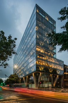 a large glass building sitting on the side of a road