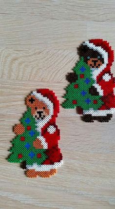 two small teddy bears with christmas decorations on them