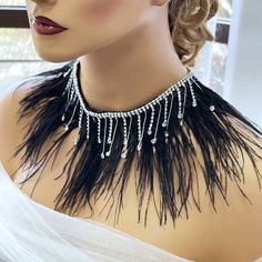 "Gothic Feather Bib Necklace - Black Fringe Choker for Gothic Weddings, Ballroom Accessory, Unique Evening Gift" Step into a world of dark elegance with our handcrafted Gothic Feather Bib Necklace, a statement piece that embodies the essence of gothic charm. Meticulously assembled with lush black feathers, this fringe necklace serves as a luxurious addition to your evening or ballroom attire. Perfect for those with a taste for the dramatic, the necklace features an adjustable choker design, ensu Adjustable Gothic Style Necklaces For Wedding, Adjustable Gothic Style Necklace For Wedding, Black Feathered Jewelry For Party, Black Feather Jewelry For Party, Elegant Adjustable Jewelry For Costume Party, Elegant Feather Jewelry For Festivals, Adjustable Feather Jewelry For Weddings, Ballroom Accessories, Ballroom Necklace