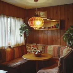 a living room with wooden paneling and a round table