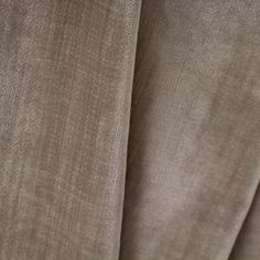 close up view of the side of a curtain with a light brown fabric on it