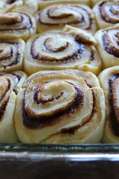 cinnamon rolls in a glass baking pan ready to be baked into the oven for breakfast