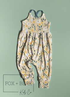 The Yellow Daisy Cross Strap Romper! These adorable rompers are a perfect outfit for transitioning into spring! Pair with a cute cardigan for the cooler mornings and remove for the warmer afternoons! They are made with a super soft, stretchy rib knit fabric. Available in a number of beautiful, vibrant prints and colors. They are a pull-on style romper with cross back straps and loose, flowy fit for easy dressing and maximum comfort!  Features: 92% polyester 8% spandex *Fun prints on a super soft and stretchy Ribbed knit fabric *Fully lined, fitted bodice *Loose, flowy pants with fitted cuff  *Cross back straps *Fabric is pre-washed to prevent shrinking All items are made to order. SIZING Please order based off of size charts to ensure best fit. Handmade items do fit differently than many s Cute Cotton Onesie For Spring, Cute Spring Cotton Onesie, Spring Cotton Jumpsuits And Rompers For Loungewear, Spring Floral Print Cotton Bubble Romper, Casual Bubble Romper With Floral Print For Spring, Casual Floral Print Bubble Romper For Spring, Casual Sleeveless Floral Print Bubble Romper, Summer Bubble Romper For Spring Playdate, Playful Floral Print Bubble Romper For Spring