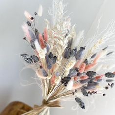 a bunch of dried flowers in a vase