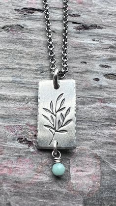 A tiny genuine birthstone has been wrapped in sterling silver. The natural gemstone dangles from a small silver rectangular pendant. I have cut the rectangle from a sheet of solid sterling silver. I then stamped a branch into the center of the pendant and lightly hammered the border. The pendant hangs from a sterling silver chain which features a lobster claw clasp and a 3-inch extender allowing the chain to be slightly adjustable.Be sure to see all photos and video for size and color reference. Color Reference, Patina Finish, Personalized Birthday Gifts, Birthstone Necklace, Chain Ring, Silver Jewellery, Lobster Claw, Sterling Silver Chains, Bracelet Making