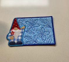 a patch with a gnome on it sitting on a table