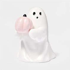 a white ghost figurine holding a pink bubble