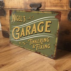 an old style garage tinkering and fixing sign sitting on top of a wooden chest