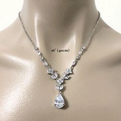 "A classic woodland wedding nature inspired teardrop bridal necklace featuring vines, leaves and flower petal pendant, made of sparkly clear cubic zirconia. This beautiful cz jewelry comes in tarnish-resistant silver rhodium plated chain. Necklace length is adjustable from 17\" (43cm) to 19\" (48cm) . View matching pieces or similar designs at https://etsy.me/2JAovjr View designs related to vines, branches, twigs or leaves at https://etsy.me/1E5j438 View designs with marquise shapes at https://e Elegant Teardrop Bridal Necklace For Anniversary, Sparkling Drop Bridal Necklace, Elegant Teardrop Crystal Bridal Necklace, Pear-shaped Cubic Zirconia Bridal Necklace For Wedding, Bridal Drop Necklace With Sparkling Cubic Zirconia, Teardrop Crystal Bridal Necklace With Elegant Design, Wedding Cubic Zirconia Teardrop Crown, Cubic Zirconia Teardrop Crown Wedding Jewelry, Wedding Teardrop Crown Cubic Zirconia Jewelry