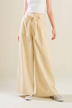 A solid woven pant featuring front closure, self sash tie, front pleat and wide leg Cotton Wide Leg Pants With Belt, Spring Solid Color Belted Wide Leg Pants, Belted Wide Leg Cotton Pants, Belted Wide Leg Pants For Spring, Solid Color Wide-leg Pants With Tie Waist, Belted Cotton Wide Leg Pants, Wide Leg Pants With Tie Waist For Work, Workwear Wide Leg Pants With Tie Waist, Cotton Paperbag Waist Pants With Tie