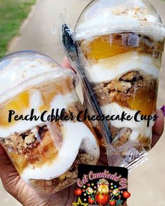 two desserts in plastic cups are being held by someone's hand with the words peach cobbler cheesecake cups