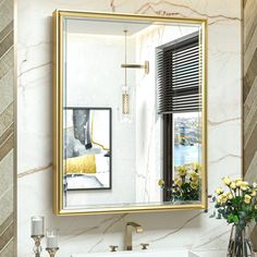 a bathroom sink sitting under a mirror in front of a wall mounted faucet