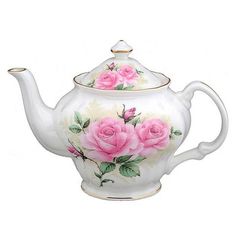 a white tea pot with pink roses painted on it