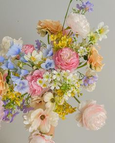 a vase filled with lots of different colored flowers