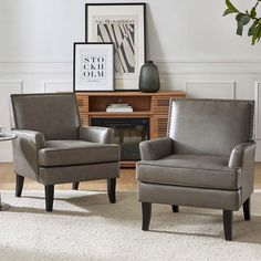 two gray chairs sitting next to each other in a living room