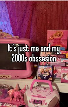 a pink computer sitting on top of a desk next to other toys and books with the caption it's just me and my 2000s obsession