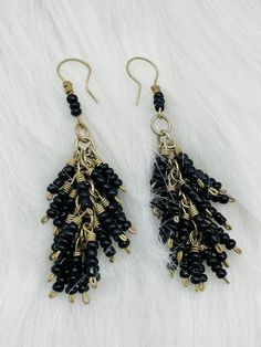 Ethnic earrings - beaded in black beads Nepal Tibet, Kochi, Afghan silver coral stone earring Your order will be sent in a box or gift bag The Kouchis are a nomadic people who are among the Pashtun tribes. They live in the Hindu Kush mountains, between Afghanistan and Pakistan. They take care of their herds of livestock in their daily life. These are jewelry worn by nomads for a long time. Each piece is original, with its little rough edges that give it its charm. Bohemian Black Beaded Dangle Jewelry, Traditional Black Beaded Earrings, Bohemian Black Dangle Jewelry, Black Bohemian Dangle Jewelry, Black Dangle Plug Earrings As Gift, Black Dangle Plug Earrings For Gift, Traditional Dangle Black Bead Jewelry, Black Metal Beads For Jewelry Making, Gift Black Beaded Dangle Jewelry