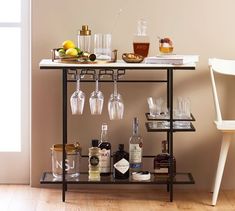 a bar cart filled with liquor glasses and bottles