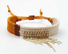 two different colored bracelets with gold and silver beads on white background, closeup