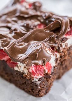 a piece of cake with chocolate frosting and strawberries