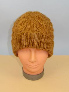 a mannequin head wearing a brown knitted hat