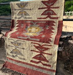 an old rug is displayed on the ground