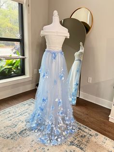 Add a touch of beauty and your something blue to your wedding day with our Blue 3D Flowers Detachable Bridal Skirt. The detachable feature allows for a quick change from ceremony to reception, while the snap buttons provide easy removal. Make a statement with this unique and stunning addition to your wedding dress.