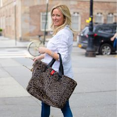 This year's must-have accessory is our Grey Leopard Oversized Faux Fur Reversible Tote! Its oversized laptop pocket and interior waterproof zip pocket provide you with plenty of space for all of your day-to-night necessities. The two-in-one design of faux fur and waterproof SatinTex™ allows you to switch up your look for any occasion. With this fun, functional bag, you'll be sure to stand out from the crowd. Chic Travel Shoulder Bag With Faux Fur Lining, Rectangular Travel Shoulder Bag With Faux Fur Lining, Trendy Faux Fur Bag For Everyday Use, Faux Fur Shoulder Bag For Daily Use, Everyday Faux Fur Tote Shoulder Bag, Everyday Faux Fur Shoulder Bag With Fur Trim, Everyday Faux Fur Trim Shoulder Bag, Faux Fur Shoulder Bag For Everyday Use, Travel Tote Bag With Faux Fur Lining