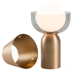 an egg is sitting on top of a stand next to a glass bowl and metal object