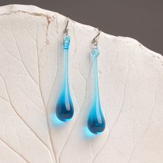 "These Light blue long teardrop dangle earrings are made of glass in lampwork technique. The stainless steel hooks are hypoallergenic. They will not tarnish, fade, or discolor with time. These unique and beautiful earrings are like water drops frozen in glass! They are simple and elegant, very lightweight and comfortable to wear, perfect for everyday wear and for special occasions. You will definitely receive lots of compliments on your new earrings, everybody loves them, and you'll love them to Long Teardrop Earrings, Modern Long Drop Teardrop Earrings Gift, Elegant Turquoise Drop Teardrop Earrings, Turquoise Teardrop Drop Earrings With Ear Wire, Modern Blue Teardrop Jewelry, Modern Blue Long Drop Earrings, Modern Blue Long Drop Jewelry, Modern Blue Teardrop Earrings, Blue Teardrop Drop Earrings