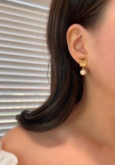 These captivating clip-on earrings feature a delicate golden square pendant embellished with a lustrous pearl. Our hypoallergenic clip-ons effortlessly blend style and comfort. No more tightness or hassle. Elevate your look effortlessly! *(Free Cushion Pad Included) Dimensions:  0.4"length X 1" height. Material:  High quality Copper with 14k Gold Plating + Pearl Free shipping on orders totaling $50 and up 🎁 Every order will be carefully packaged with love for delivery. 💕 Elegant Rectangular Clip-on Earrings For Formal Events, Classic Gold Square Earrings, Elegant Gold Plated Square Jewelry, Gold Square Earrings For Formal Occasions, Gold Square Earrings For Formal Events, Elegant Square Gold Jewelry, Elegant Gold Rectangular Clip-on Earrings, Gold Rectangular Clip-on Earrings, Gold Square Earrings For Anniversary