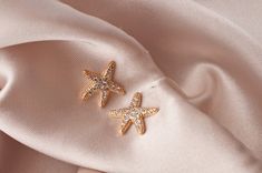 "Looking for a meaningful and spiritual jewelry gift, that is equally stunning? Our \"Sea Star\" starfish earrings are the perfect spiritual yet dazzling gift for your best friend. At a glance, they appear to be inspired by the famous sea creatures, but if you look under the surface there is much more to these gold starfish stud earrings. Starfish represents divine love, protection, and regeneration. These beautiful sea star stud earrings in gold feature tiny crystal zirconia diamonds glimmering Elegant Starfish Charm Jewelry For Gifts, Elegant Starfish Charm Jewelry Gift, Elegant Starfish Charm Jewelry As Gift, Starfish Shaped Jewelry With Star Charm As Gift, Minimalist Starfish Jewelry Gift, Rose Gold Star Earrings For Gift, Rose Gold Earrings With Star Charm As A Gift, Starfish Earrings With Star Charm As Gift, Starfish-shaped Earrings With Star Charm For Gift