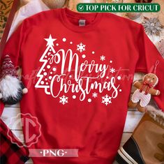 a red sweater with the words merry christmas on it and some other items around it