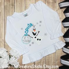 I love Summer! Olaf Inspired Custom Shirt! Olaf is probably my favorite character from the Frozen movie! I love Warm Hugs! :) When checking out, please indicate -Shirt Size -Name to be embroidered. Please DOUBLE check the spelling. I keep ONLY WHITE shirts and bodysuits in stock, but can sometimes accommodate requests for different colors. Convo me prior to purchasing if you are interested in a shirt color other than white. We try our best to accommodate all custom requests. Please convo us with Character Crew Neck Cotton Top, Cotton Character Print Tops, Long Sleeve T-shirt With Character Print For Disney Events, Fan Merchandise Long Sleeve Shirt With Character Print, Character Print Long Sleeve Shirt For Fans, Disney Cotton T-shirt For Birthdays, White Themed Shirt For Disney Fan Events, Themed White Shirt For Disney Fan Events, Disney Crew Neck Top For Birthday