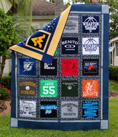 a blanket made out of t - shirts on the grass in front of a house