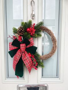 a christmas wreath hanging on the front door