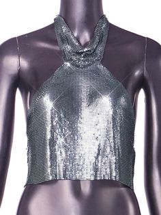 Metal halter turtleneck top. Chic Cropped Halter Top For Club, Chic High Neck Tank Top For Night Out, Evening Party Season Halter Neck Tank Top, Stretch High Neck Crop Top For Party, Glamorous Halter Neck Top For Spring, Chic High Neck Tops For Parties, Party Season Halter Neck Tank Top For Night Out, Trendy Halter Neck Top For Club, Trendy Halter Neck Top For Night Out