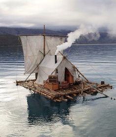 a boat floating on top of water with steam coming from it's back end