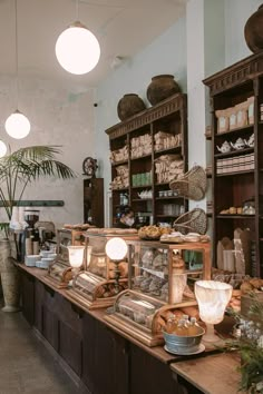 the interior of a bakery with lots of bread on display