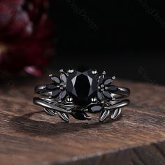 a black diamond ring sitting on top of a wooden table