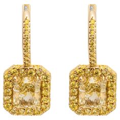 Earrings in 18k Yellow Gold With 2 Fancy Light Yellow Radiant Cut Diamonds: 1.50ct Fancy Light Yellow VVS2 Radiant Shape Diamond GIA#2456872042 1.50ct Fancy Light Yellow VS1 Radiant Shape Diamond GIA#5453858760 Total carat weight of fancy yellow pave: 0.76ct Yellow Diamond Earring, Fancy Light, Fancy Lights, Fancy Yellow Diamond, Radiant Cut Diamond, Diamond Earring, Radiant Cut, Yellow Diamond, Light Yellow