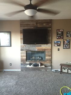 a living room with a television mounted on the wall