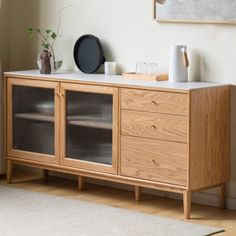 a wooden cabinet with glass doors in a living room