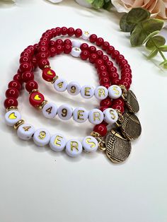 Super cute Stretch 49ers Football Charm Bracelet. Bright Red Glass Beada with White Circle Alphabet Beads  Show your support for your team this season!  All bracelets are 7 inches big  Need a smaller size, message me! 👍🏼  I appreciate your business and do my little happy dance with every sale!  I hope you can see my real passion and attention I give to making each piece.  PLEASE READ BEFORE PURCHASE Look at sizes of bracelets and measure your wrist before ordering.**   Since I use natural gemstones, beads, patina metal, & lava beads, the size, shape, and colors used may vary. Each desktop, Laptop computer, iPad, and cell phone will give you a slightly different look. I try to take my pictures as true as they are in person. Please read the description of each item you are interested in so Customized Red Wristband For Friendship, Personalized Red Beaded Bracelets For Friendship, Personalized Red Beaded Friendship Bracelets, Adjustable Red Bracelets For Sports Events, Red Letter Beads Jewelry, Red Beaded Charm Bracelet For Friendship, Red Jewelry With Round Letter Beads, Red Letter Beads For Gifts, Red Team Spirit Bracelets For Gifts