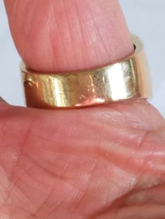 This Men's Gold Tone Art Deco Ring is now being listed just in time for Father's Day. The ring is made in a gold tone metal with a round setting with a Cubic Zirconia at the center. Tiny round glass rhinestones are hand set in pairs of 2 in individual pockets. There is no hallmark on this handsome ring but it is in great vintage condition and will arrive in a ring box with FREE SHIPPING. Size: 10.5 Material: Gold Tone Metal, Round Glass Cubic Zirconia, Tiny glass Rhinestones No hallmark Ring box Gold Engraved Thick Band Jewelry, Gold Jewelry With Engraved Thick Band, Gold Brass Rings With Round Band, Vintage Gold Engraved Round Band Ring, Vintage Gold Engraved Ring With Round Band, Adjustable Wide Band Yellow Gold Ring, Gold Metal Dome Ring For Anniversary, Gold Thick Band Engraved Ring, Gold Brass Dome Ring