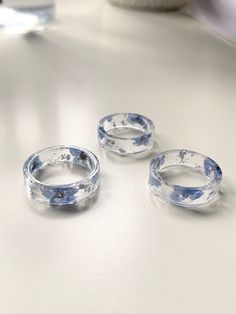 three glass rings sitting on top of a table